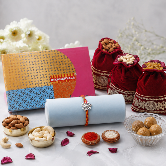Archies Silver Ganesha Charm Rakhi with Besan Laddoo and Dry Fruits