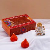 Ganesha Idol with Set of 2 Modak Diyas - Orange