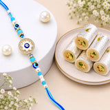 Evil Eye Wheel Charm Rakhi with Kaju Roll