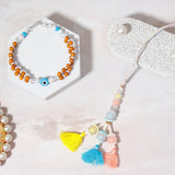 Wooden Evil Eye & Pastel Tri-Tassel Rakhi Set