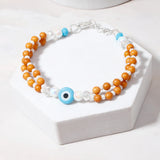 Wooden Evil Eye Bracelet Rakhi & Pastel Tri-Tassel Lumba Rakhi Set