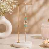 Peach and Blue Om Rakhi in Gold Finish For Brother