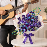 Blue Orchids & Dairy Milk Chocolate Bouquet with Guitarist