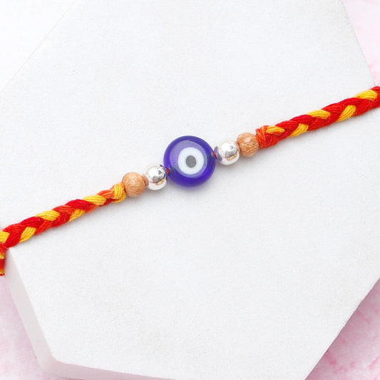 Archies Silver Evil Eye Beaded Rakhi with Besan Laddo and Dry Fruits