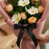 5 White Gerberas & 5 Peach Roses Bouquet in Peach Wrap with Black Ribbon