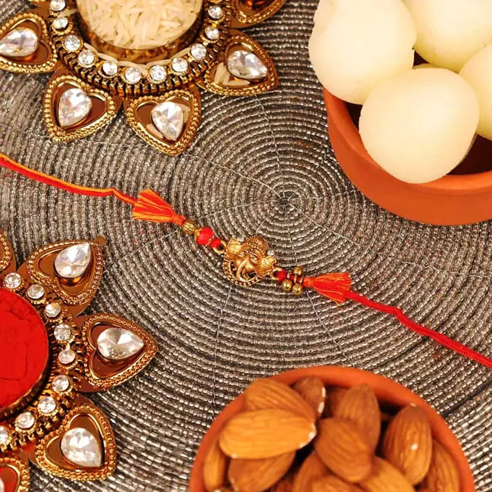Ganesha Rakhi with Tin Rasgulla and Almonds