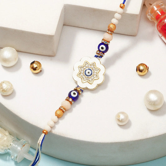 Evil Eye Flower Medallion Rakhi with Rasgulla & Dry Fruits