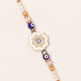 Ivory Flower Evil Eye Rakhi & UXR Royal Life Perfume Mug Set