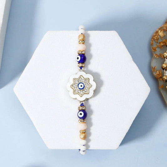 Ivory Flower Evil Eye Rakhi & UXR Royal Life Perfume Gift Set