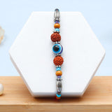 Rudraksha Evil Eye Beaded Rakhi & Archies 01 Perfume Mug Set