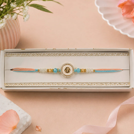 Peach and Blue Om Rakhi in Gold Finish For Brother