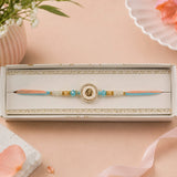 Peach and Blue Om Rakhi in Gold Finish For Brother