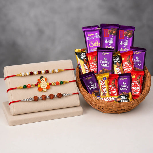 3 Rakhi With Cane Basket With 4 Dairy Milk Chocolate (13.2 Gm), 4 Kitkat Chocolate (13 Gm), 4 Five Star Chocolate (22.4 Gm), 2 Dairy Milk Silk (60Gm) And 2 Dairy Milk Fruit And Nut (40 Gm)