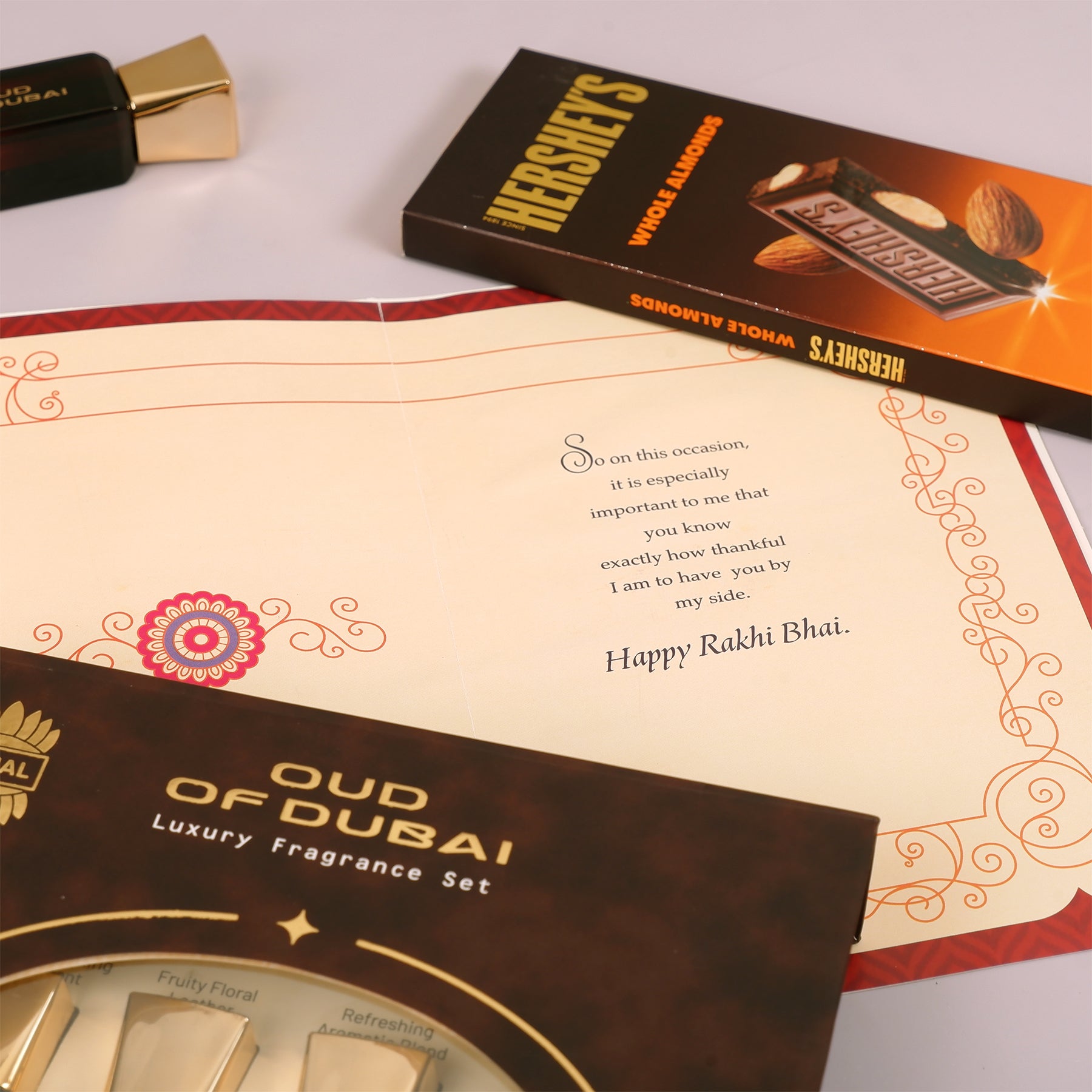 Oud Of Dubai Perfume with Rakhi Greeting Card and Hersheys Almond Bar