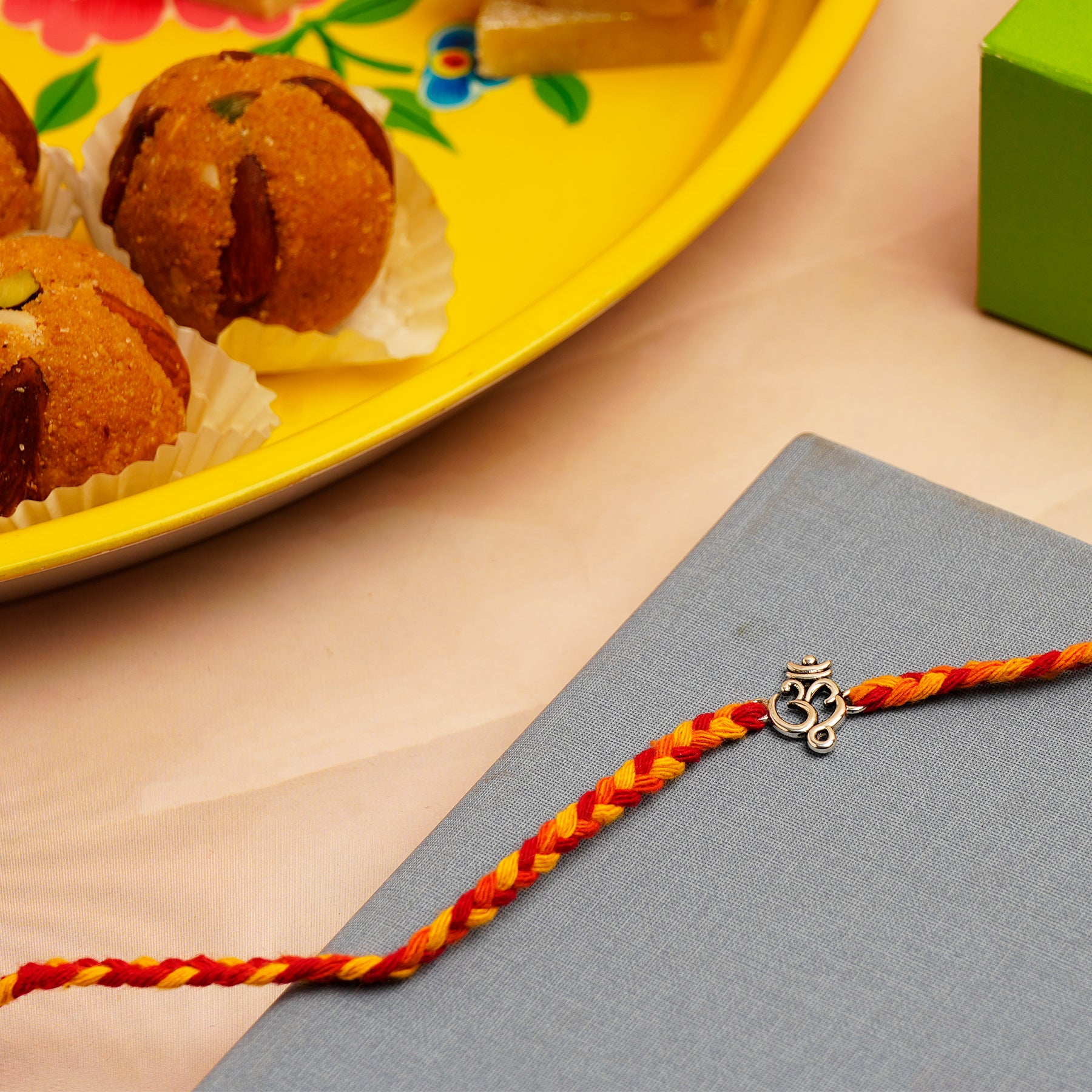 Om Silver Rakhi with Besan Ladoo