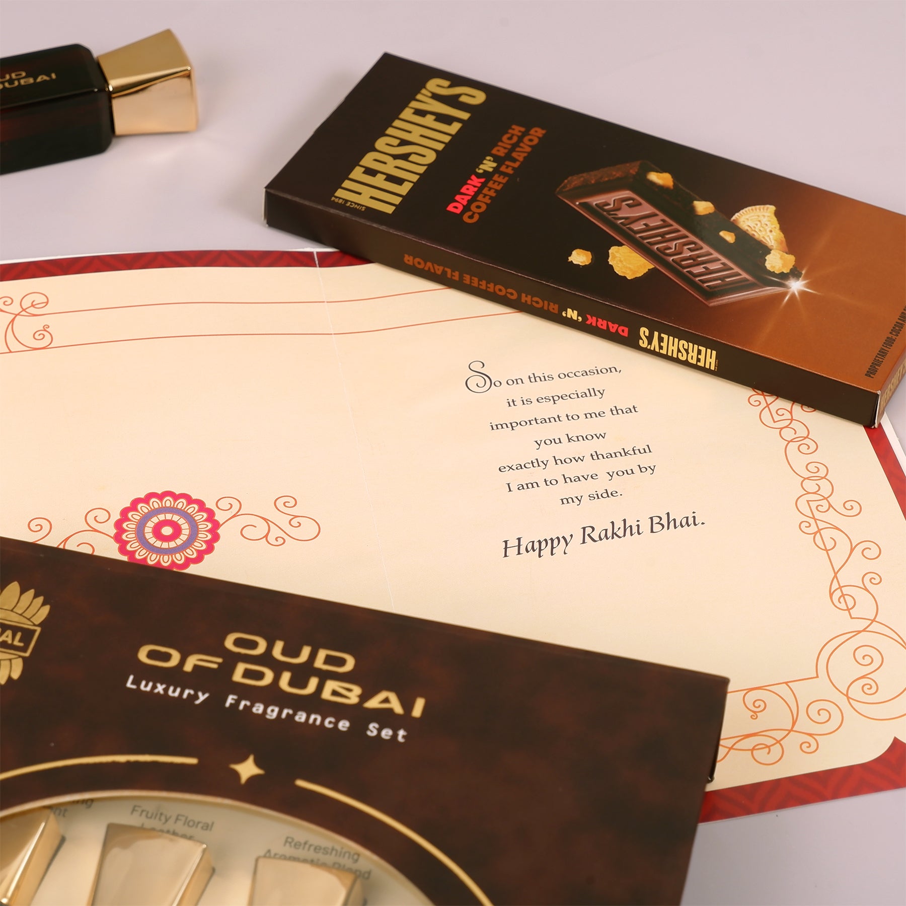 Oud Of Dubai Perfume with Rakhi Greeting Card and Hersheys Coffee Bar