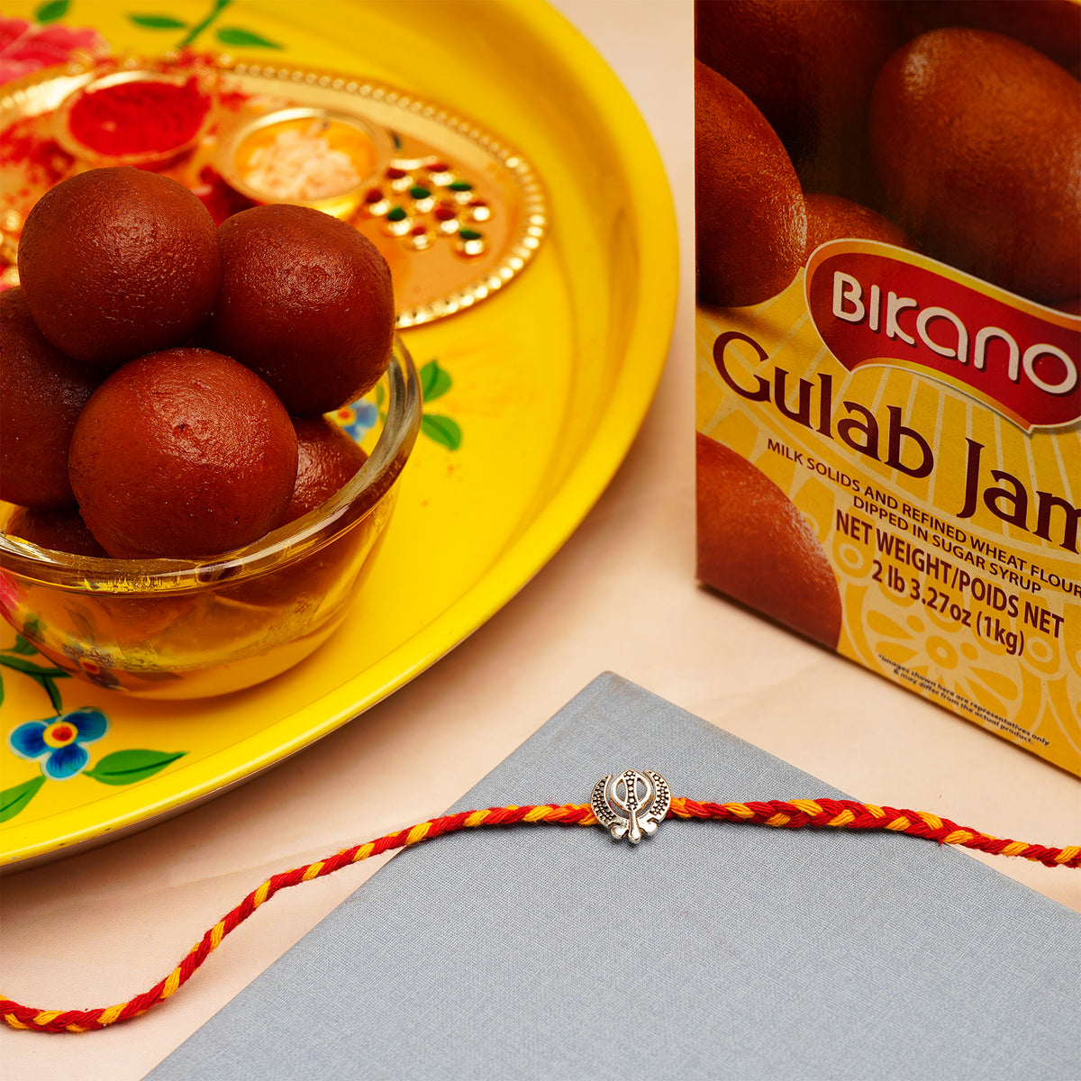 Silver Rakhi with Gulab Jamun