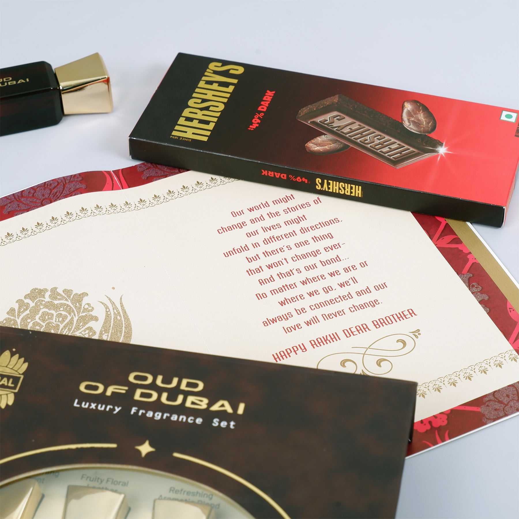 Oud Of Dubai Perfume with Rakhi Greeting Card and Hersheys Dark Chocolate Bar