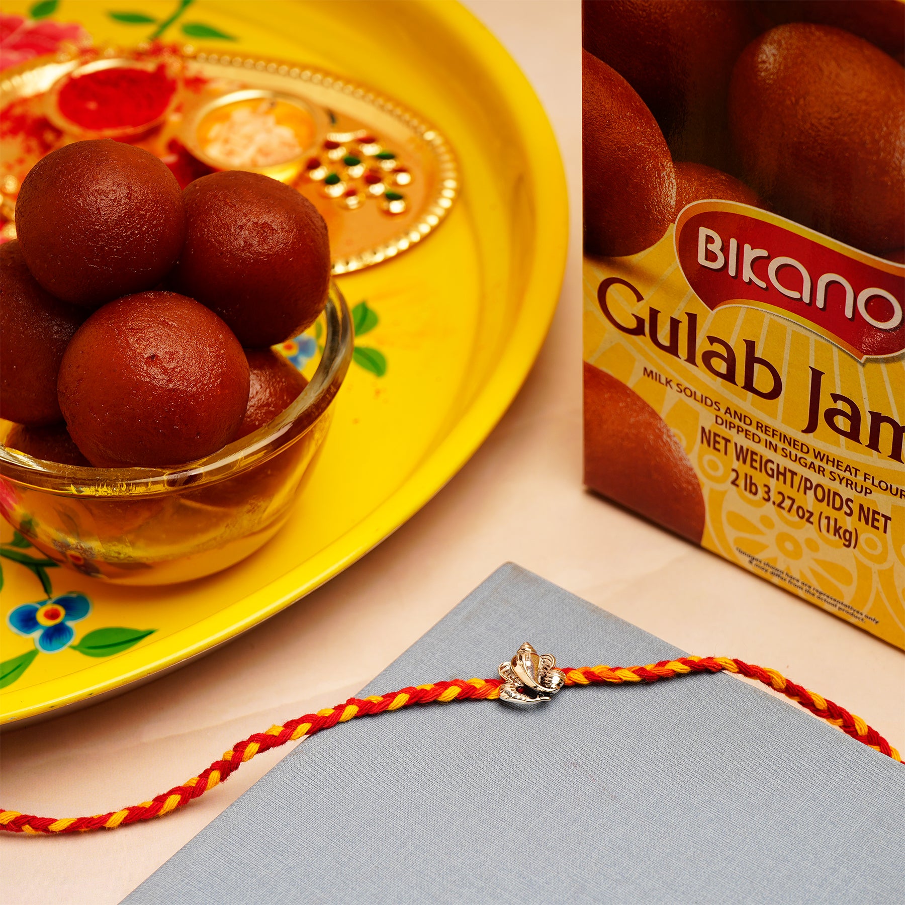 Ganesha Silver Rakhi with Gulab Jamun