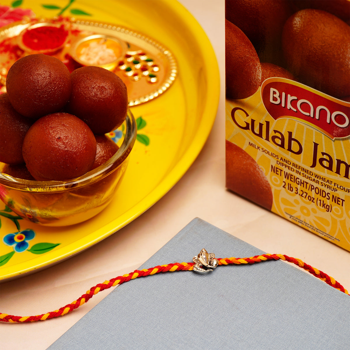 Ganesha Silver Rakhi with Gulab Jamun