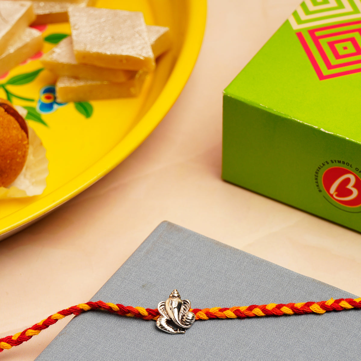 OM Ganesha Silver Rakhi with Kaju Barfi