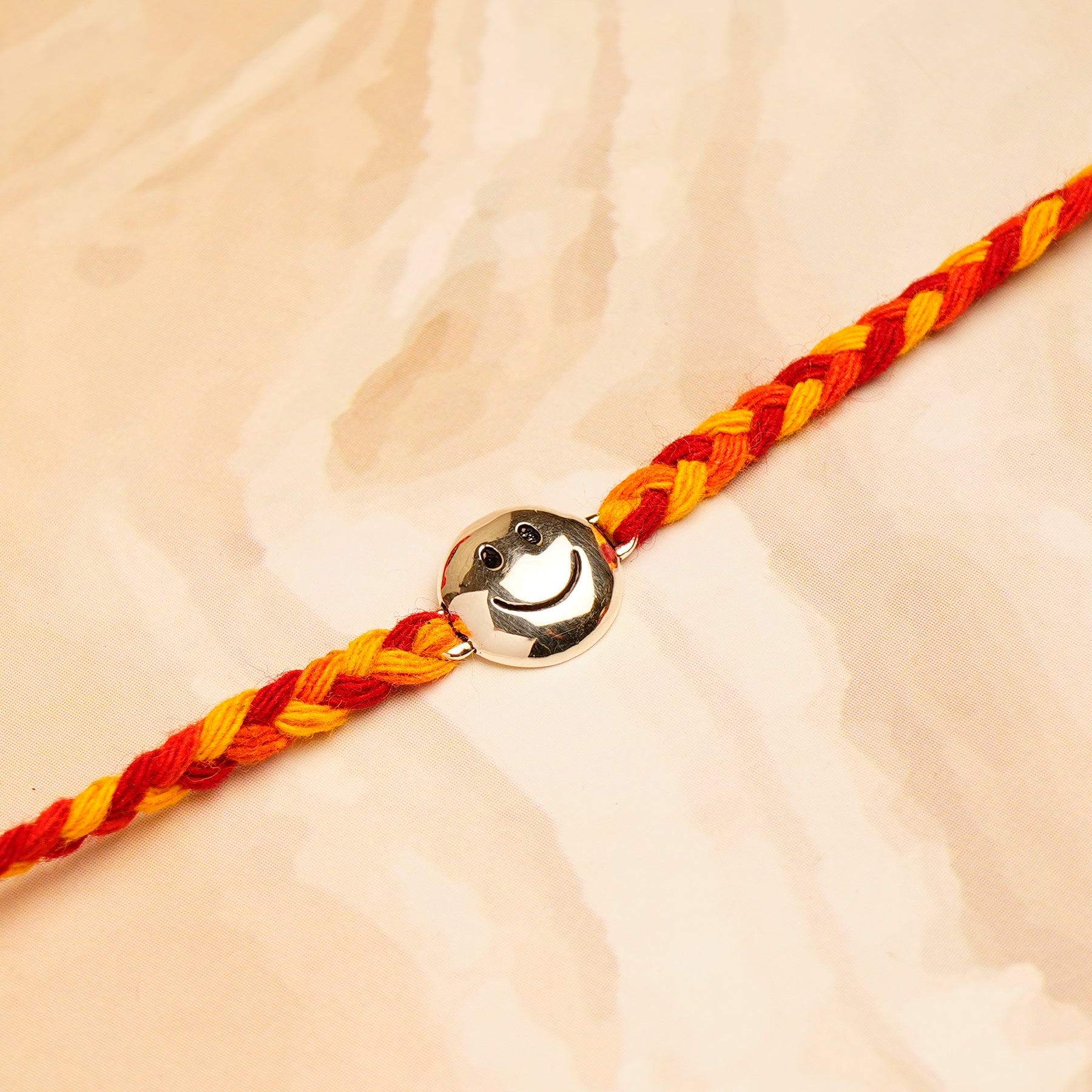 Smiley Silver Rakhi with Hersheys Kisses Hazelnut n Cookies