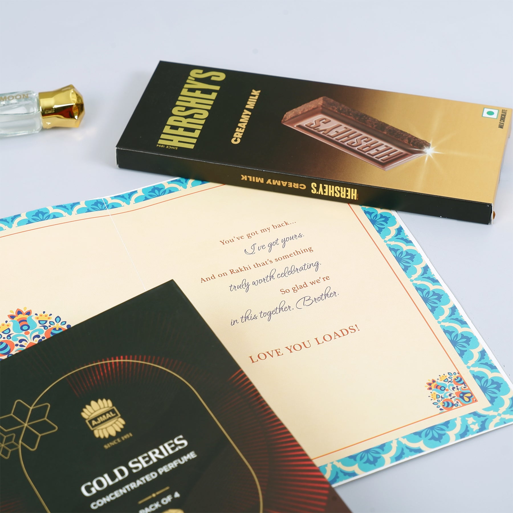 Ajmal Gold Series Perfume with Rakhi Greeting Card and Hersheys Bar