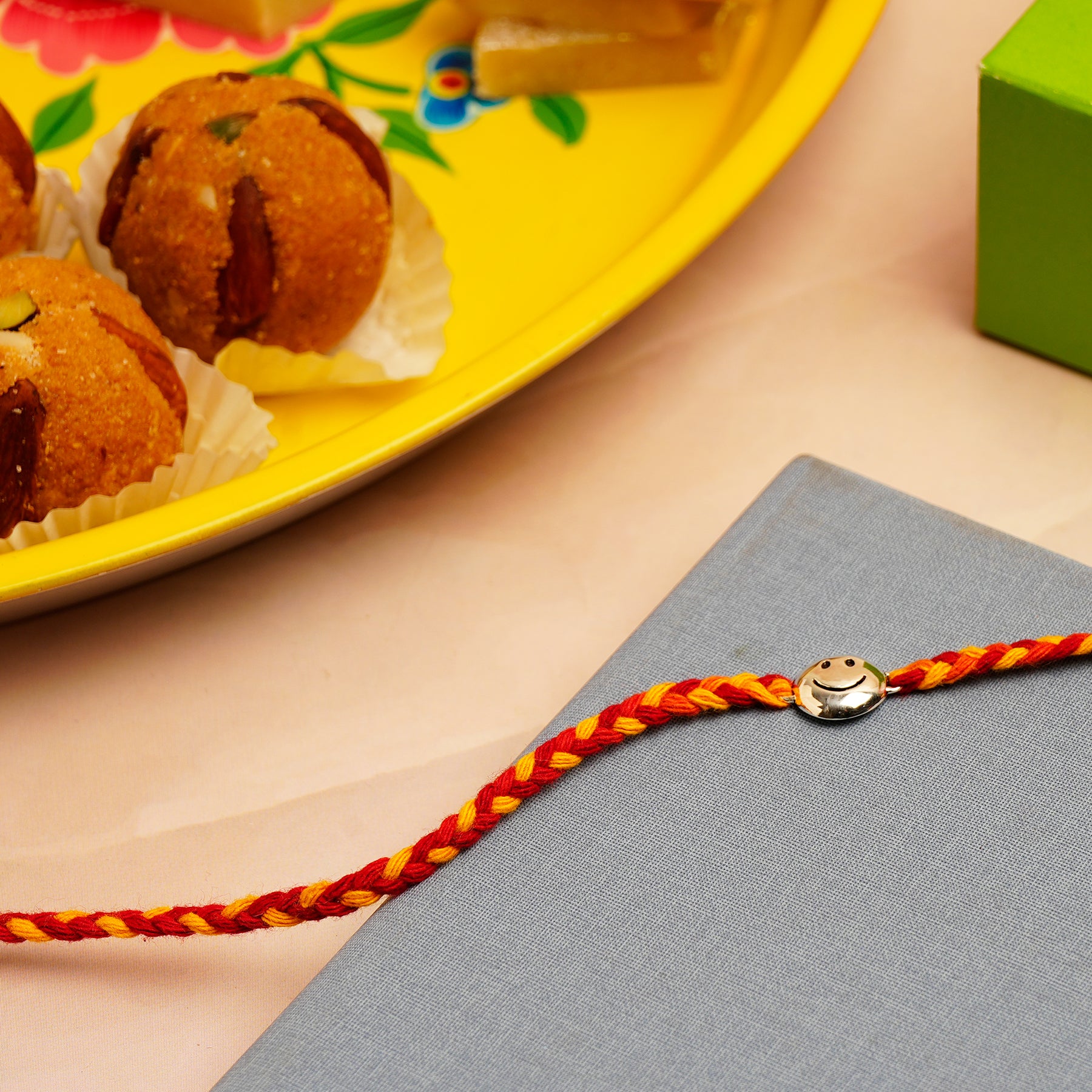 Smiley Silver Rakhi with Besan Ladoo