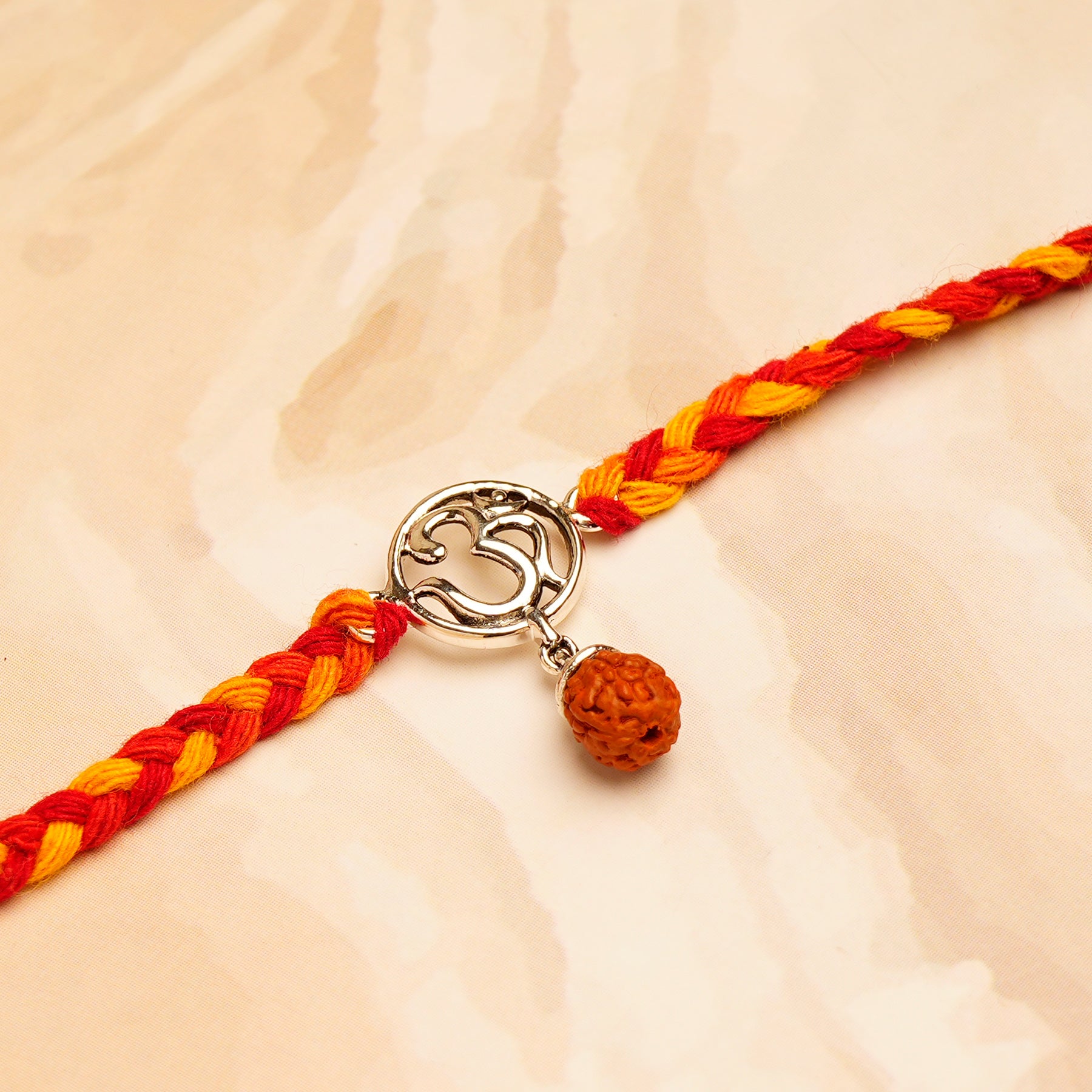 Rudraksh OM Silver Rakhi with Hersheys Kisses Hazelnut n Cookies