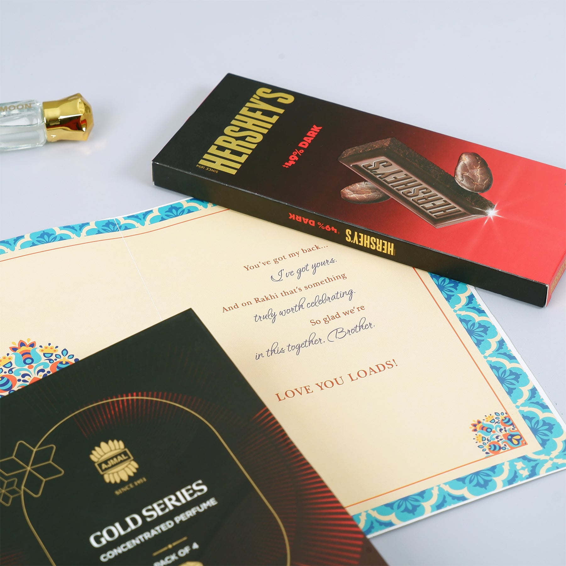 Ajmal Gold Series Perfume with Rakhi Greeting Card and Hersheys Dark Chocolate