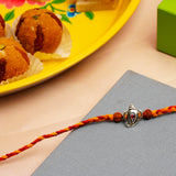 Divine Ganesha Silver Rakhi with Besan Ladoo