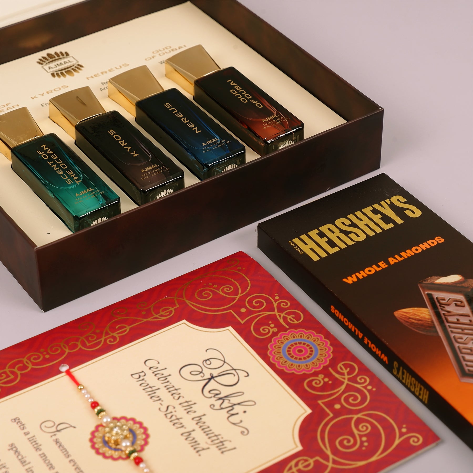 Oud Of Dubai Perfume with Rakhi Greeting Card and Hersheys Almond Bar