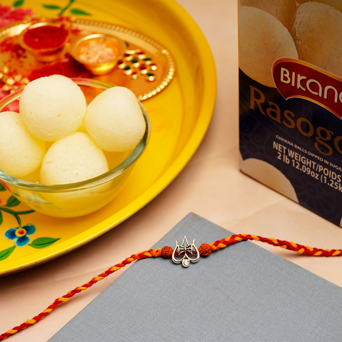 Trishul Silver Rakhi with Rasgulla