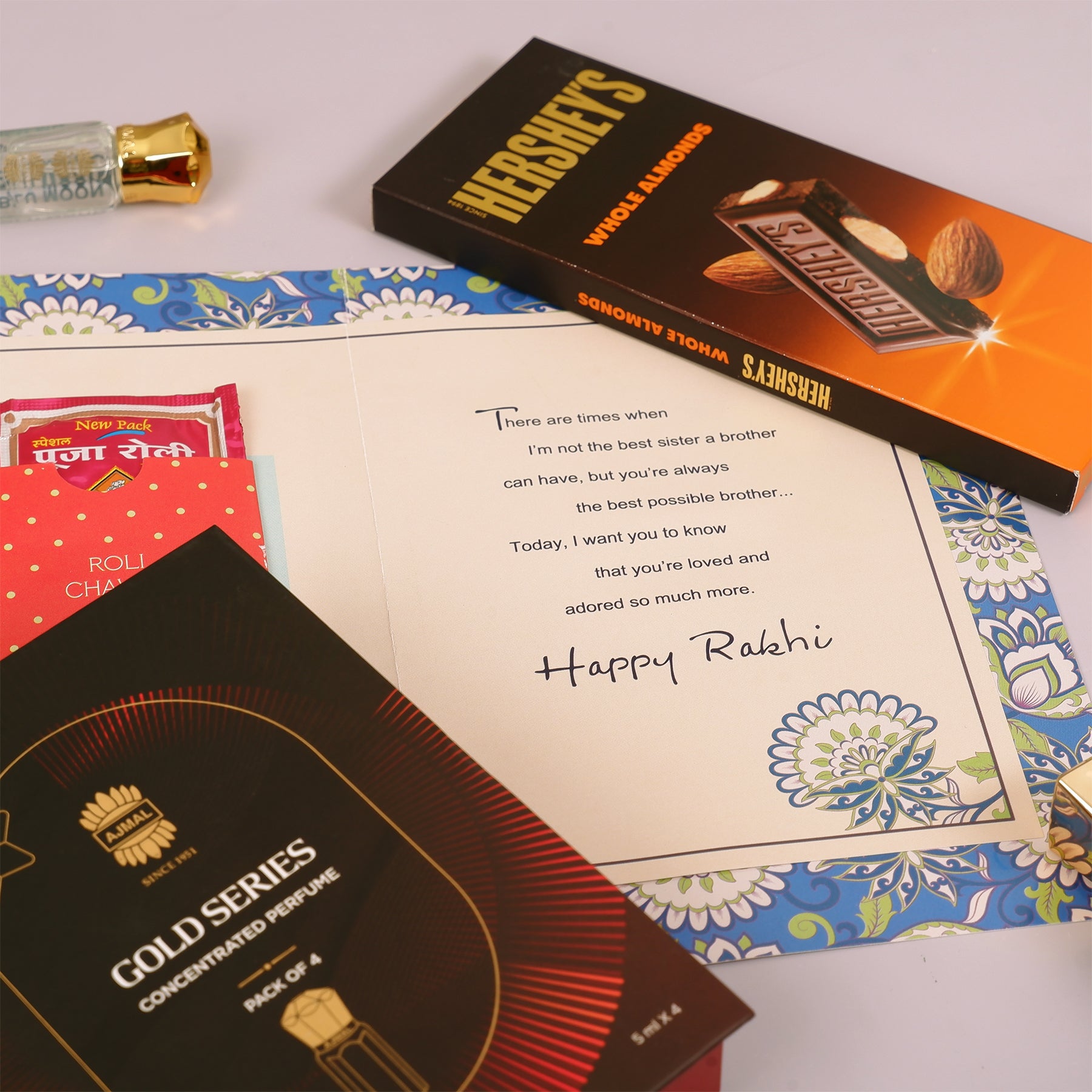 Ajmal Gold Series Perfume with Rakhi Greeting Card and Hersheys Bar Chocolate