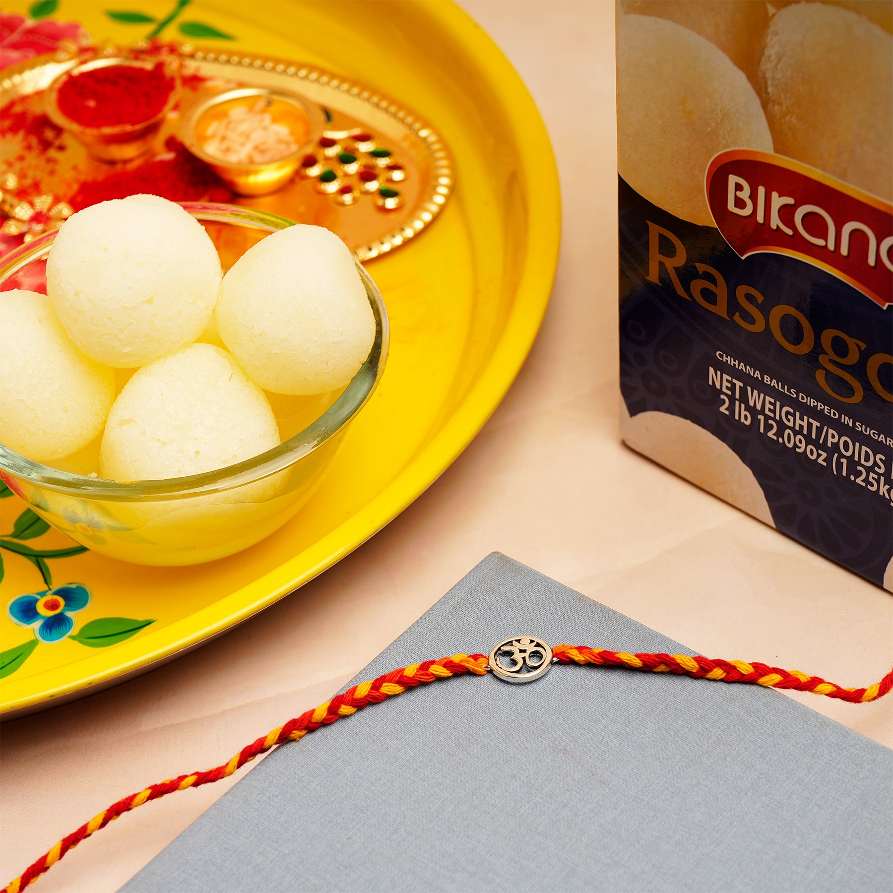 Shree OM Rakhi with Rasgulla