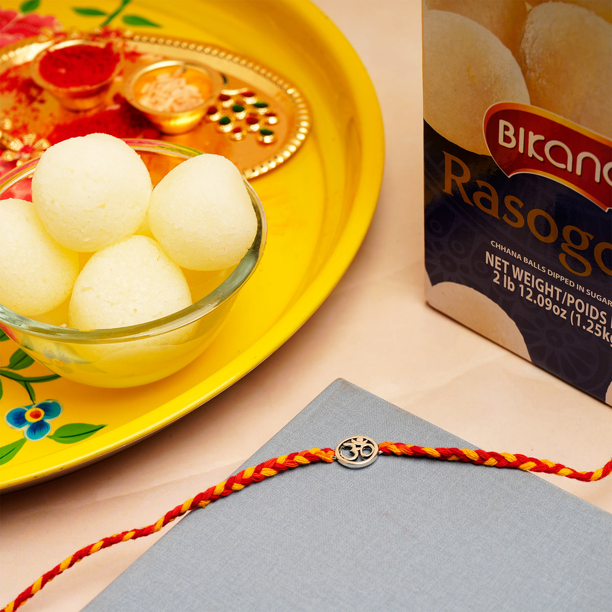 Shree OM Rakhi with Rasgulla