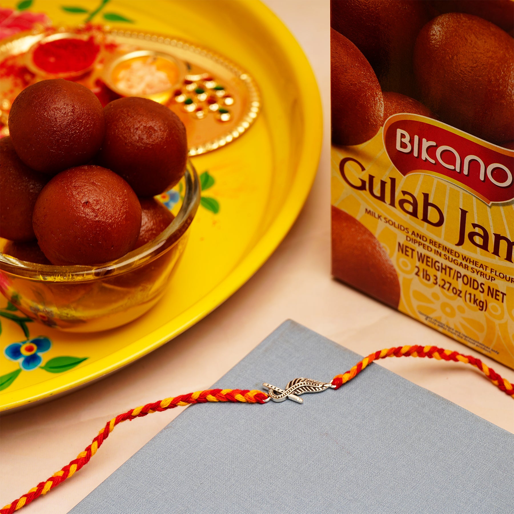 Krishna Silver Rakhi with Gulab Jamun