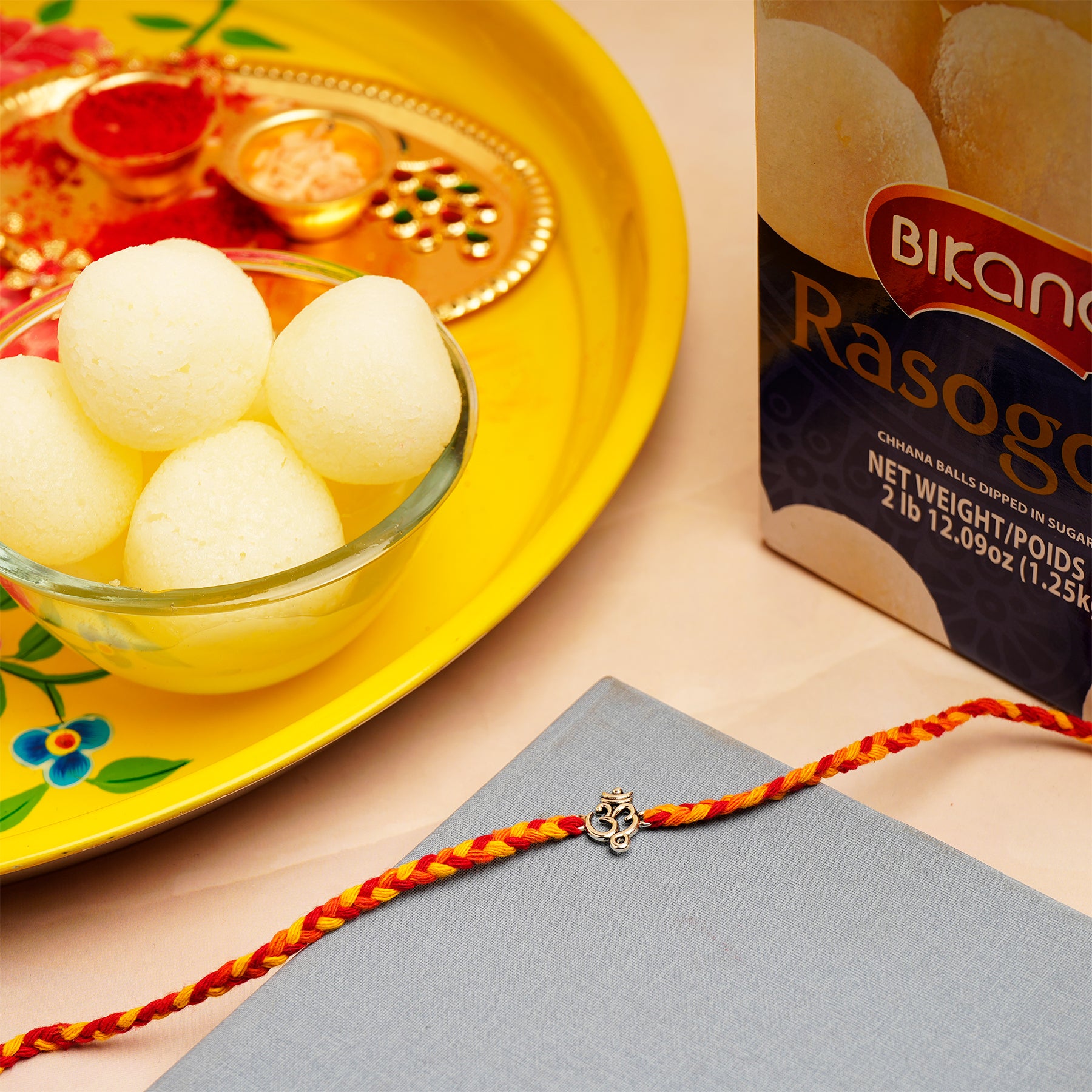 Om Rakhi with Rasgulla