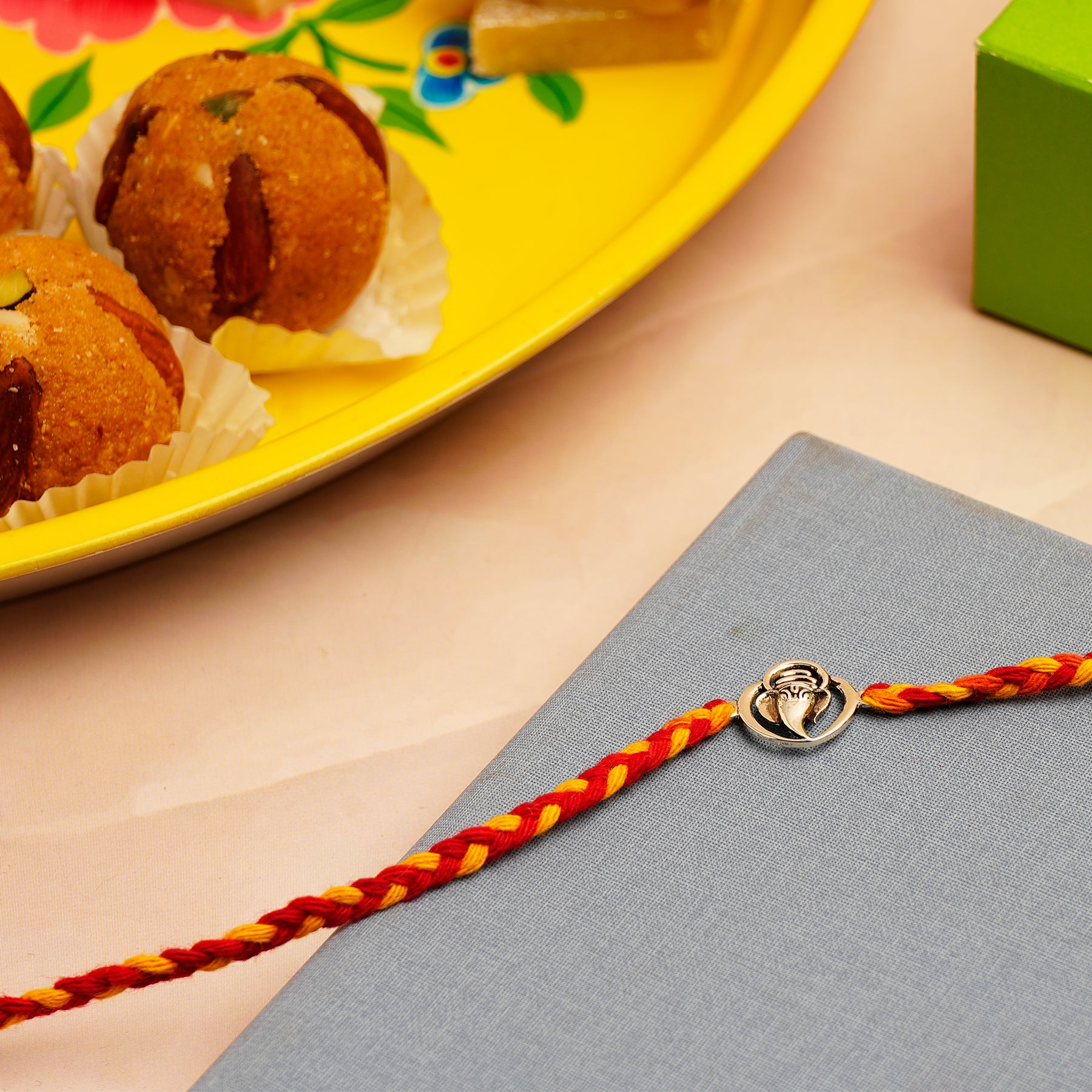 Ganesha Silver Rakhi with Besan Ladoo