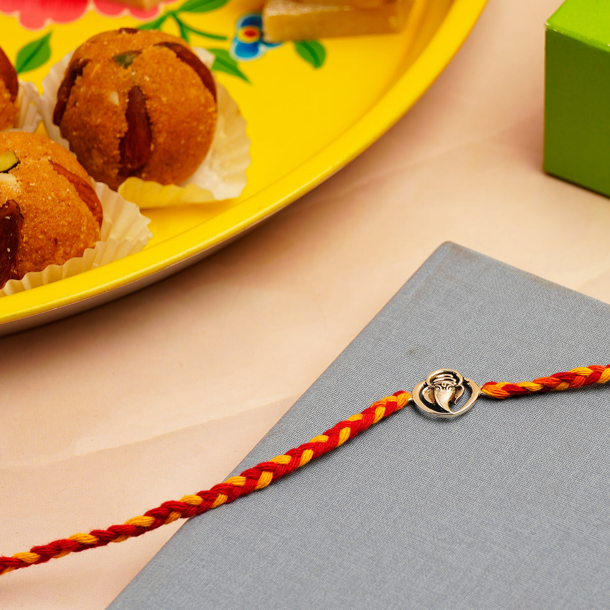 Ganesha Silver Rakhi with Besan Ladoo
