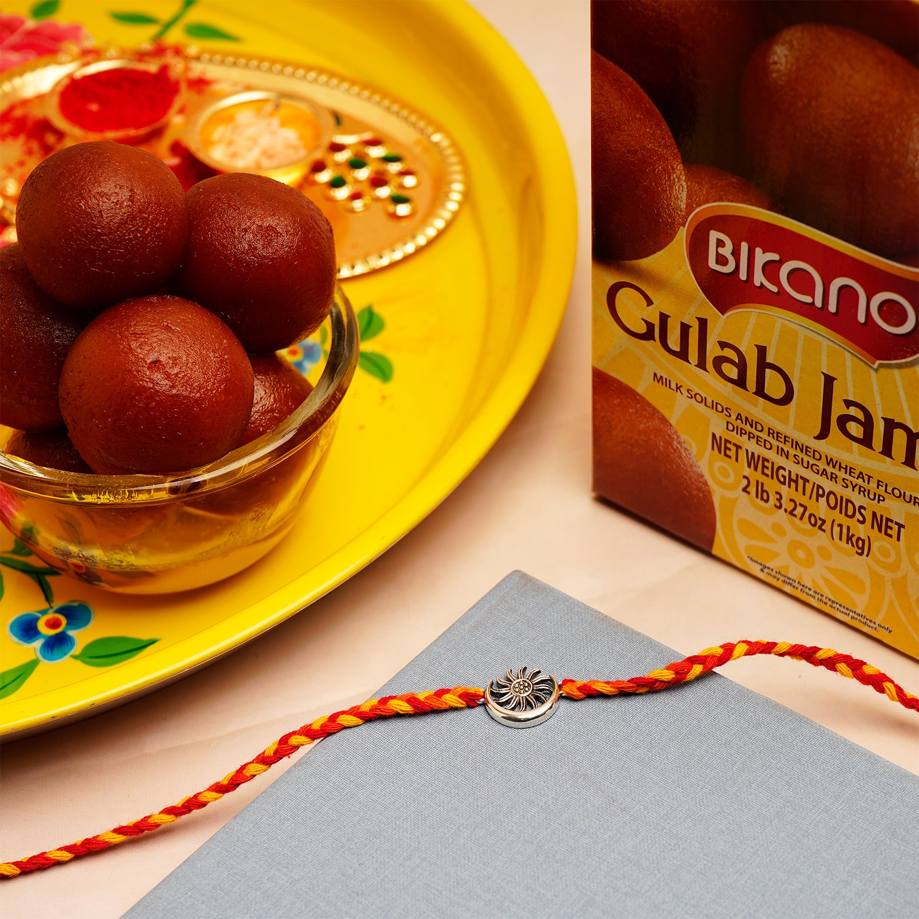 Sun Moon Silver Rakhi with Gulab Jamun