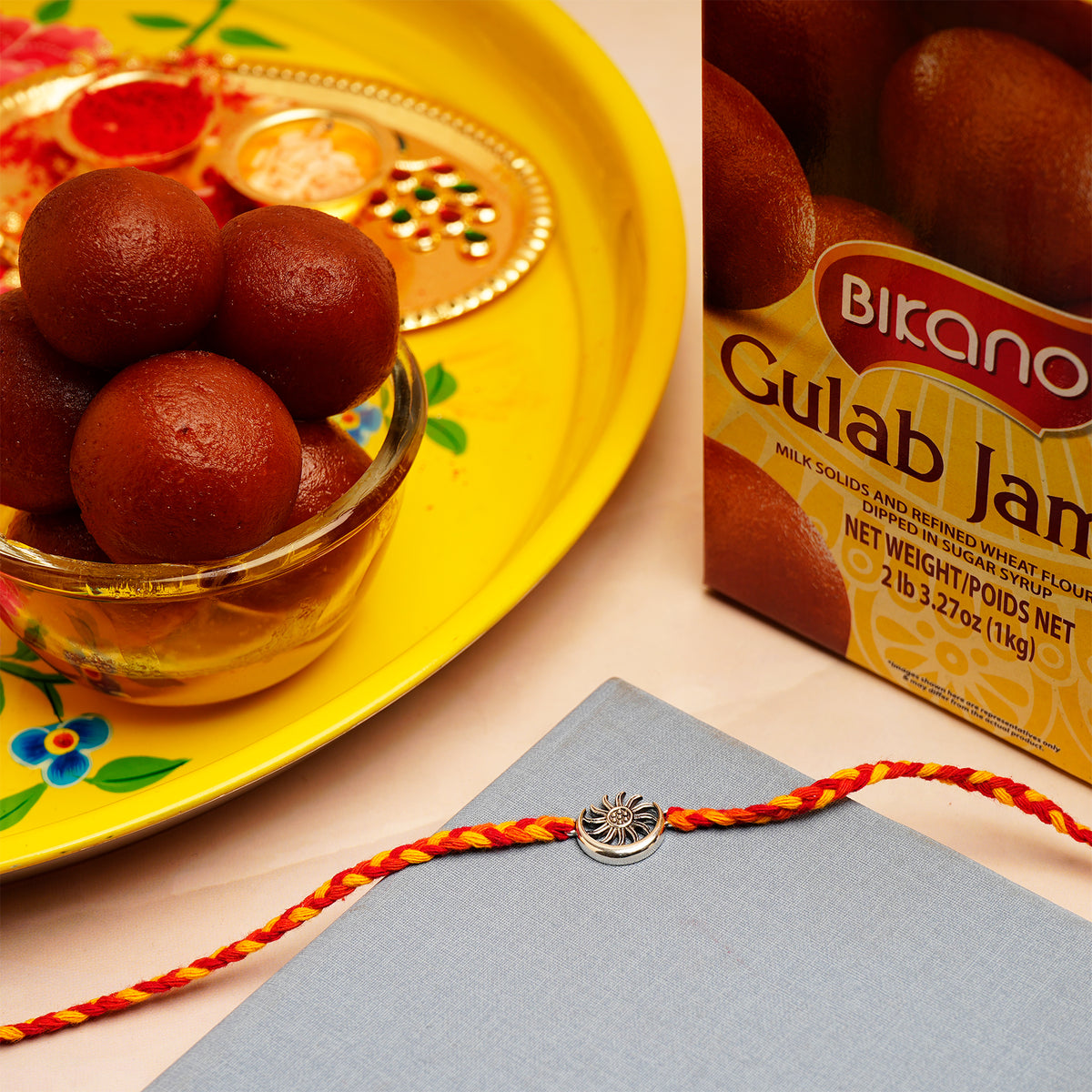 Sun Moon Silver Rakhi with Gulab Jamun