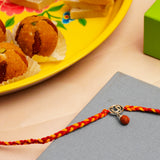 Rudraksh OM Silver Rakhi with Besan Ladoo